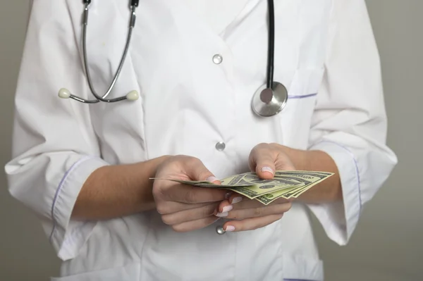 Female doctor with money — Stock Photo, Image