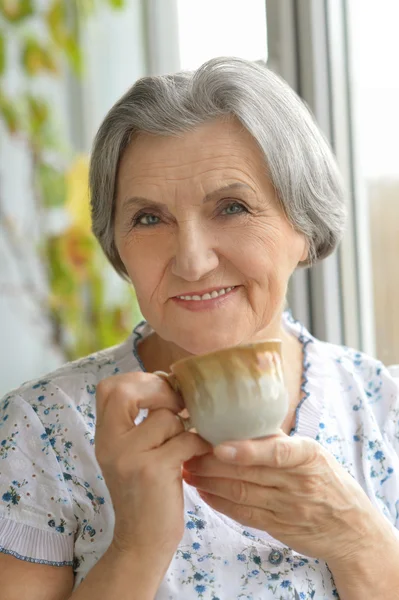 Äldre kvinna med kopp — Stockfoto