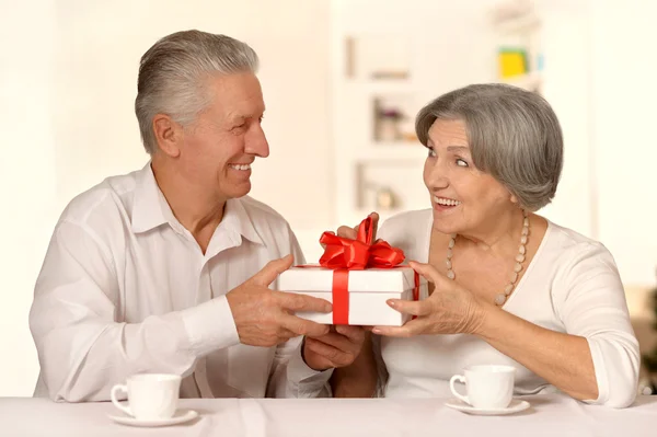 Old couple with gift — Stock Photo, Image