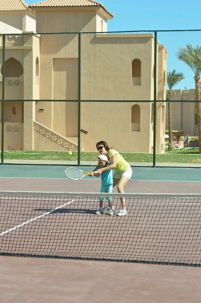 Девочка и мать играют в теннис — стоковое фото