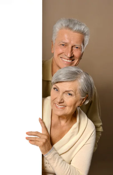 Old couple with board — Stock Photo, Image