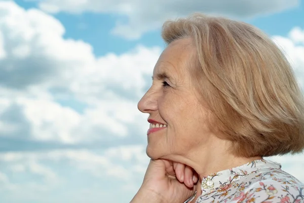 Senior woman on background of sky — Stock Photo, Image
