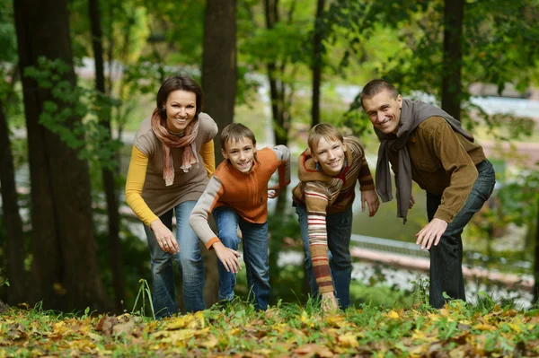 Family relaxing in autumn park — Stock Photo, Image