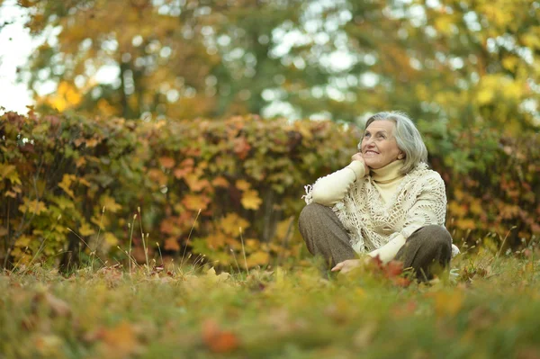 Oudere vrouw in herfstpark — Stockfoto