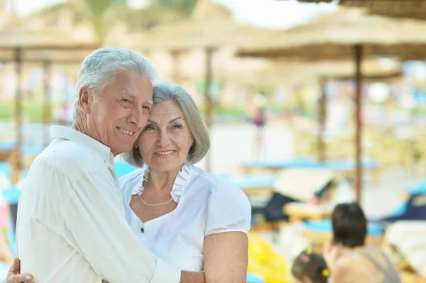 Elderly couple having rest on beach — Stock Photo, Image