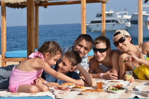 Family having lunch  on beach — Stock Photo, Image