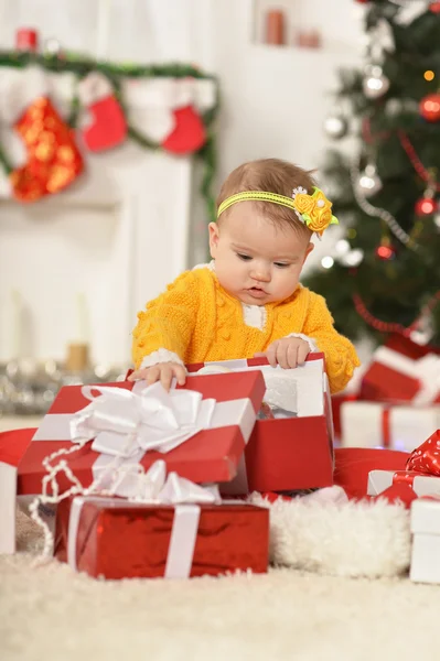 Baby girl with Christmas gifts — Stock Photo, Image