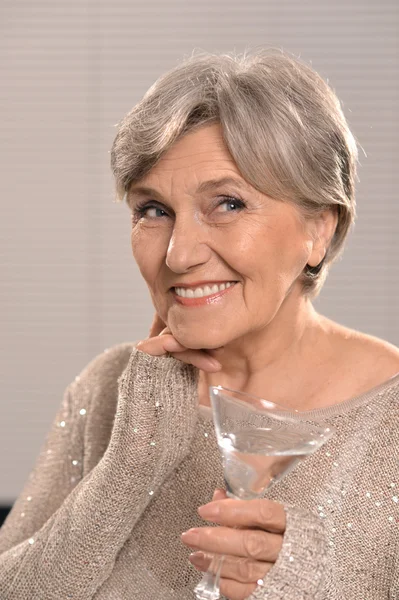 Elderly woman with glass — Stock Photo, Image