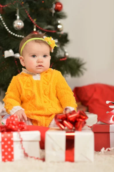 Baby girl with Christmas gifts — Stock Photo, Image