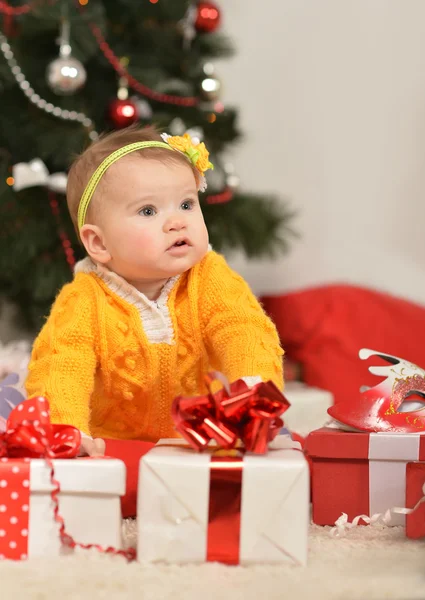 Baby girl with Christmas gifts — Stock Photo, Image