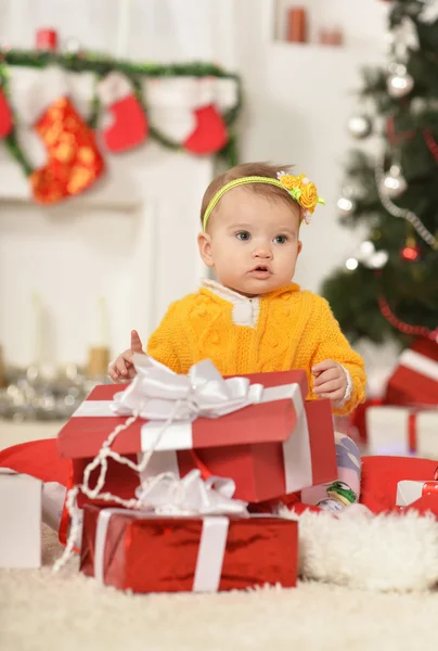 Baby girl with Christmas gifts — Stock Photo, Image