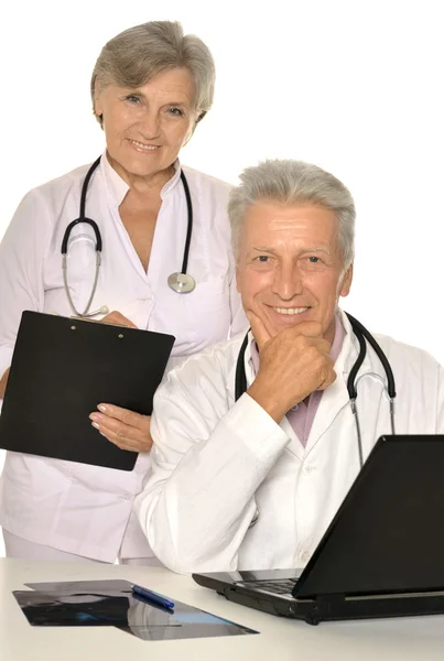 Elderly doctors with a laptop — Stock Photo, Image