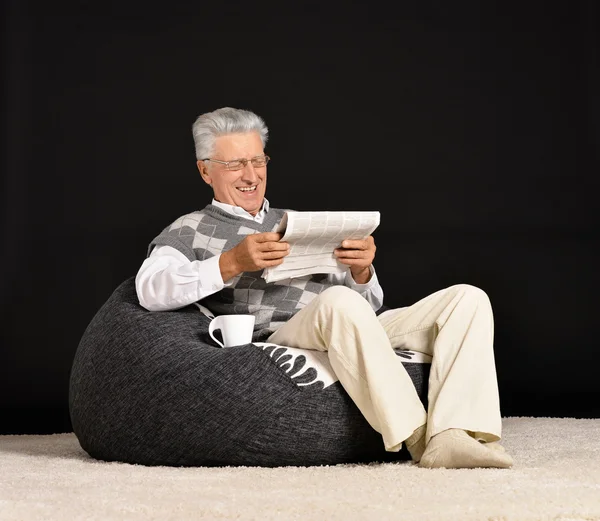 Elderly man with newspaper — Stock Photo, Image