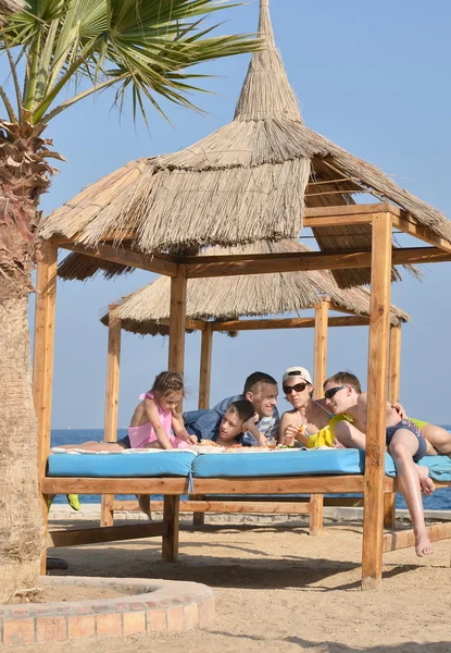 Family having lunch on beach — Stock Photo, Image