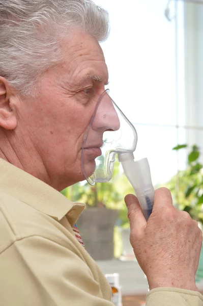 Elder man making inhalation — Stok fotoğraf