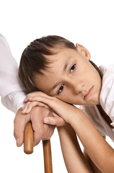 Boy leaning on  grandfather's hand — Stock Photo, Image