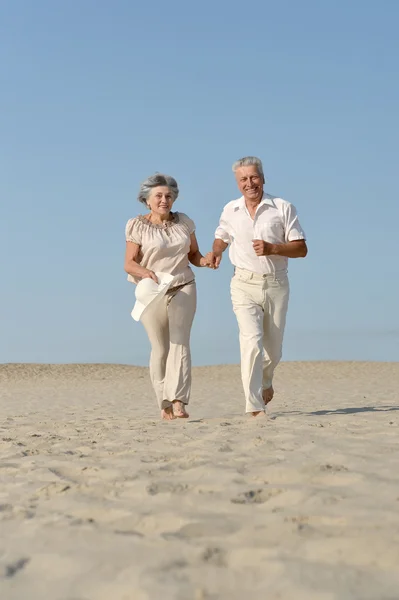 Senior couple running barefoot — Stock Photo, Image