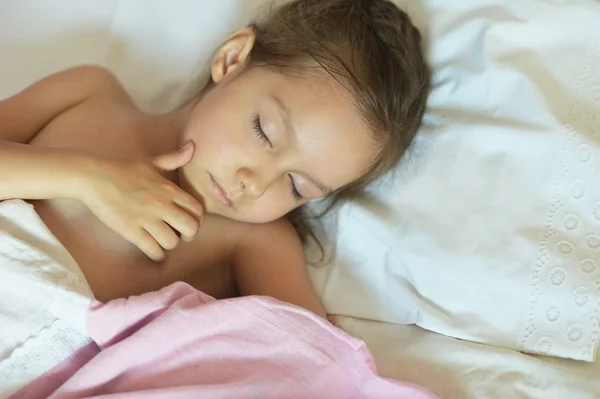 Mała dziewczynka śpi w łóżku — Zdjęcie stockowe