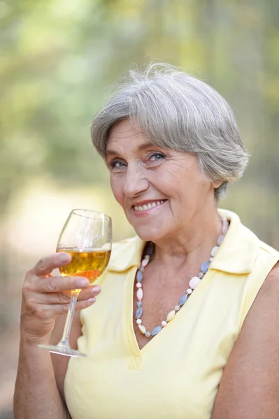 Old woman drinking wine — Stock Photo, Image