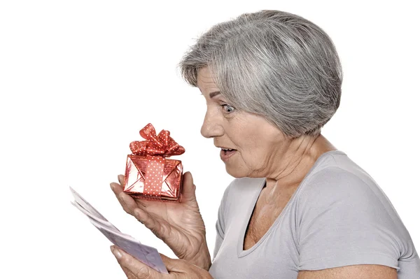 Older woman with a gift and money — Stock Photo, Image
