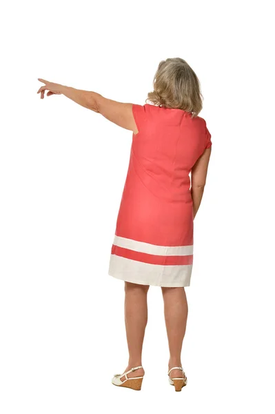 Elderly woman in dress pointing — Stock Photo, Image