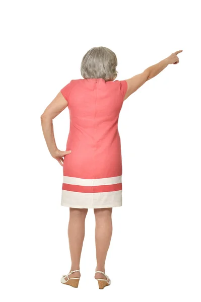 Elderly woman in dress pointing — Stock Photo, Image