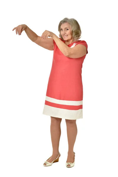 Elderly woman in dress pointing — Stock Photo, Image