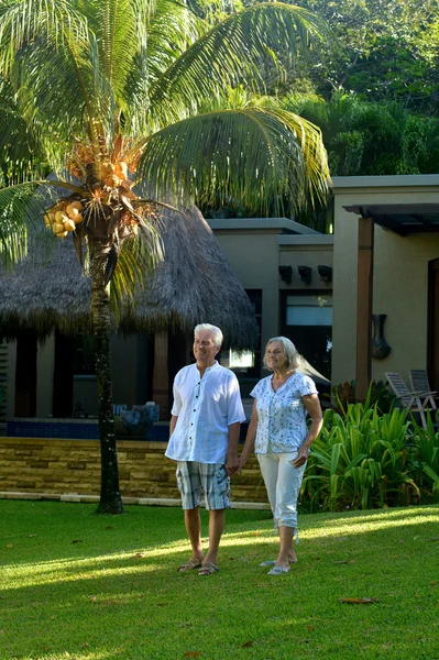 Elderly couple walking outdoors — Stock Photo, Image