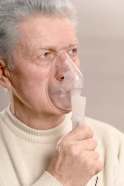 Elder man making inhalation — Stock Photo, Image