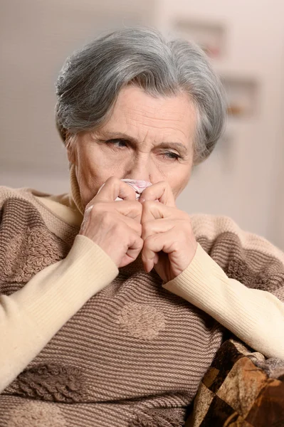 Ill elderly woman with handkerchief — Stock Photo, Image