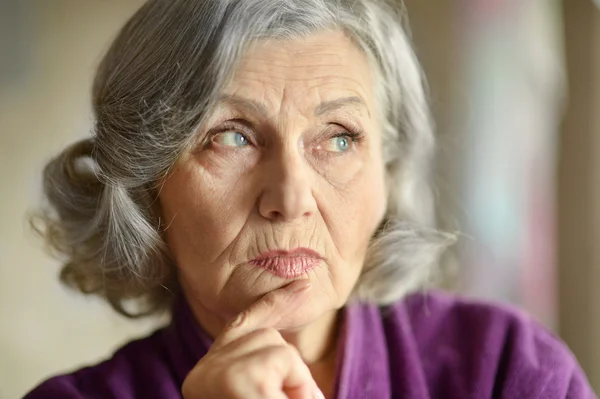 Portrait of thinking elderly woman — Stock Photo, Image