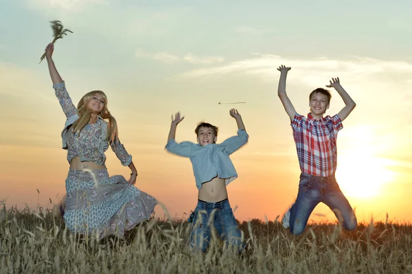 Happy mother  with sons jumping — Stock Photo, Image