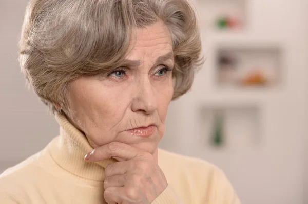 Portrait of thinking elderly woman — Stock Photo, Image