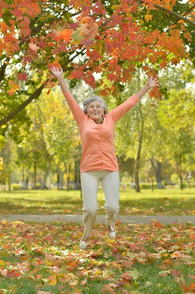 Mature woman jumping  on fresh air — Stock Photo, Image