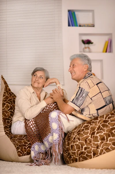 Old couple sitting at at armchairs — Stock Photo, Image