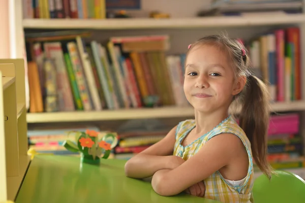 Menina sentada à mesa — Fotografia de Stock