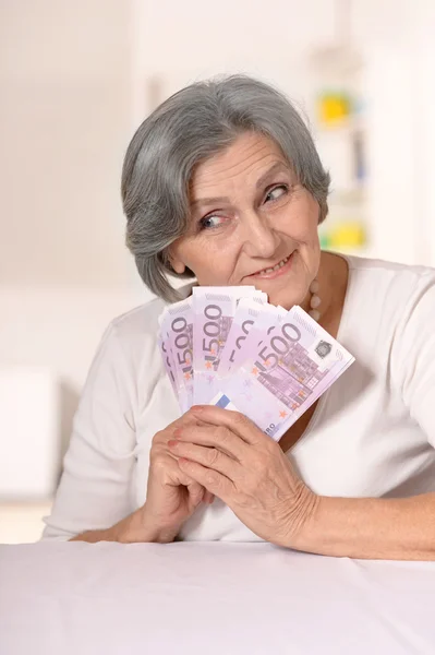 Aged woman holding euros — Stock Photo, Image