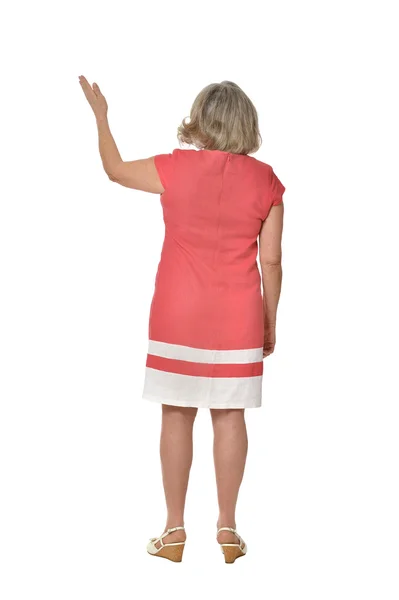Äldre kvinna i klänning pekar — Stockfoto