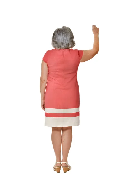 Elderly woman in dress pointing — Stock Photo, Image