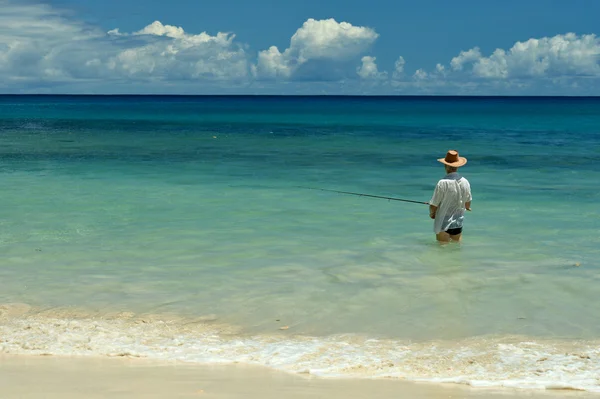 Homem idoso pesca no mar — Fotografia de Stock