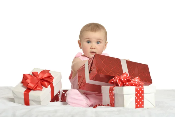 Baby girl sitting  with gifts — Stock Photo, Image