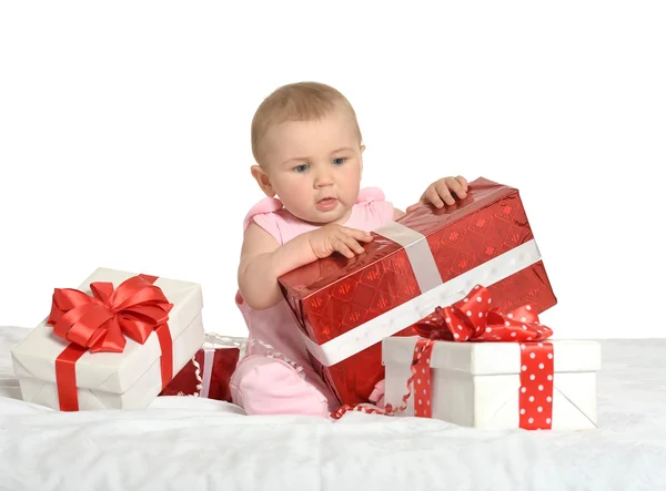 Baby girl sitting  with gifts — Stock Photo, Image