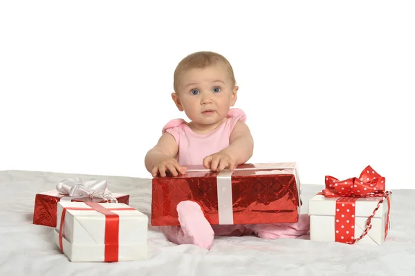Baby girl sitting  with gifts — Stock Photo, Image