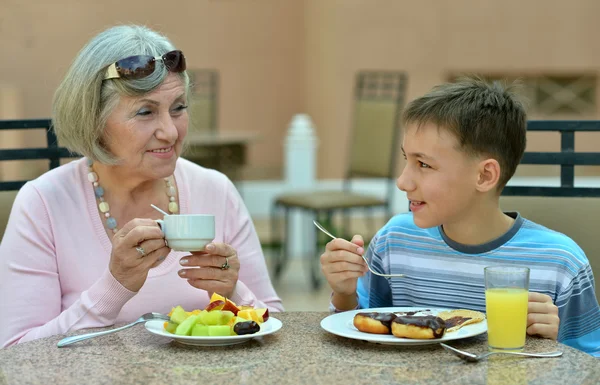 Grandmother with grandson at breakfast — Stock Photo, Image