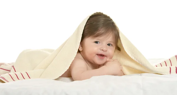 Baby girl lying under blanket — Stock Photo, Image