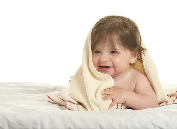 Baby girl lying under blanket — Stock Photo, Image