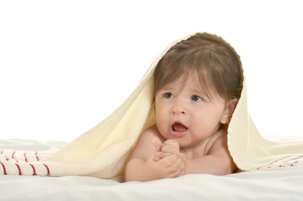 Baby girl lying under blanket — Stock Photo, Image