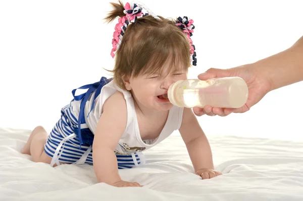 Girl crying while drinking milk — Zdjęcie stockowe