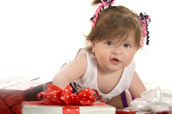 Cute baby girl  with gifts — Stockfoto