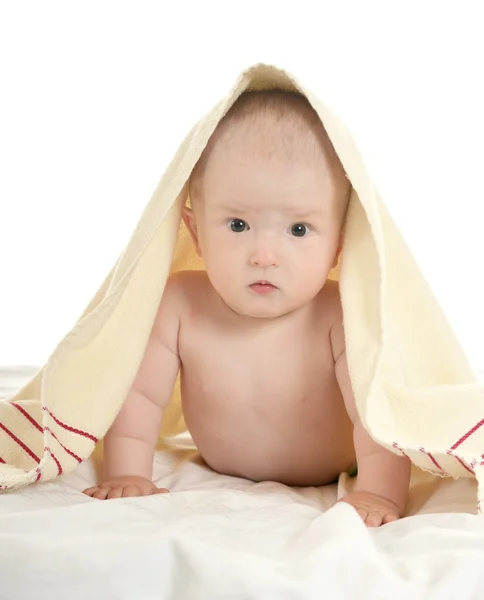 Baby girl lying under blanket — Stock Photo, Image